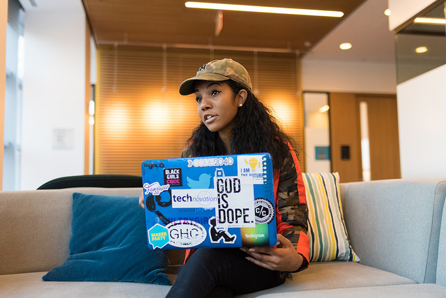 Picture of woman holding a computer and talking