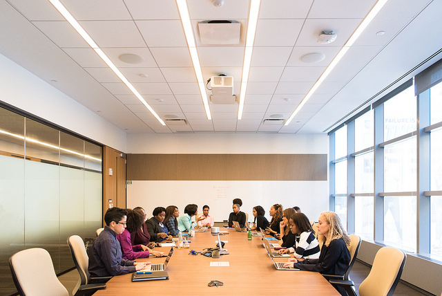 Group of women leaders sitting around a conference table