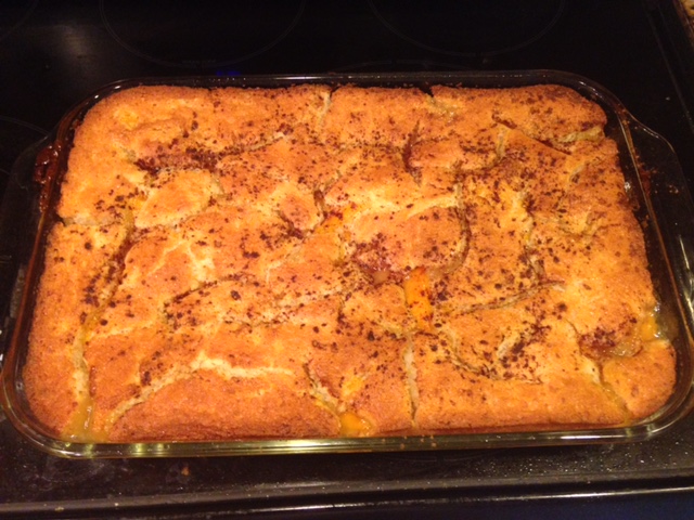 Peach Cobbler in a glass pan